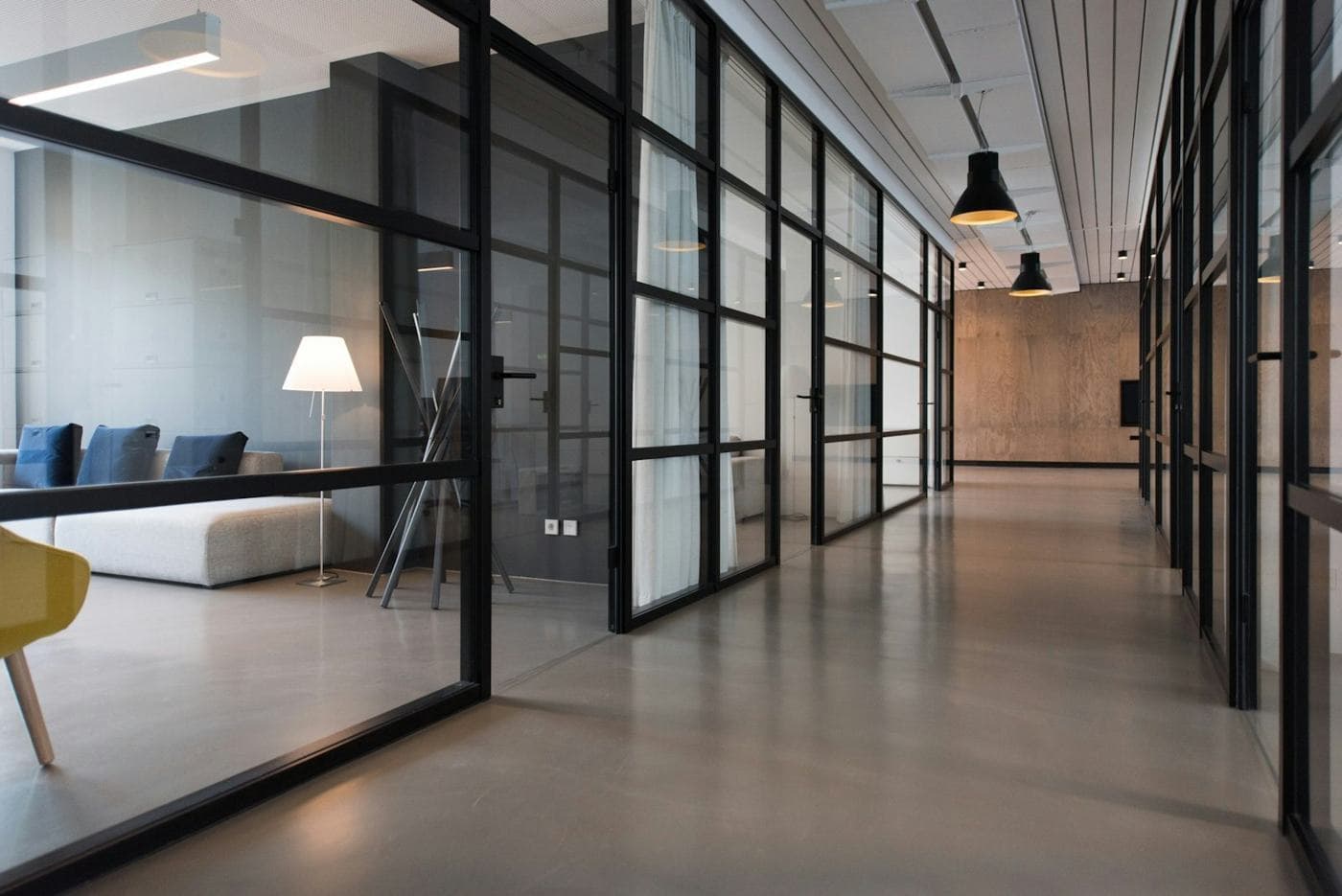 A glass-walled office hallway