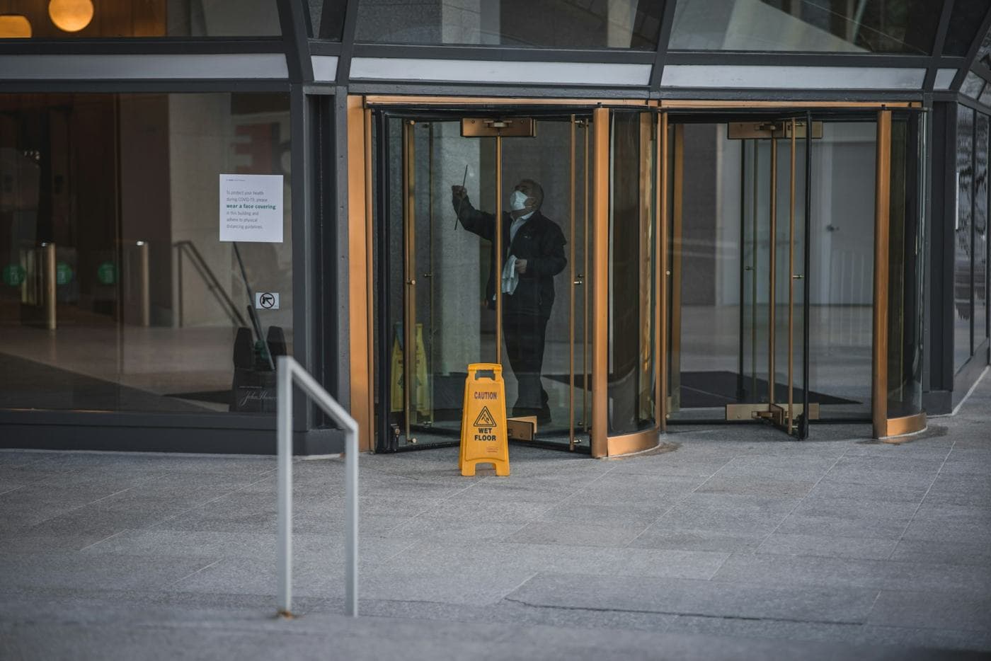 A commercial building entrance being cleaned