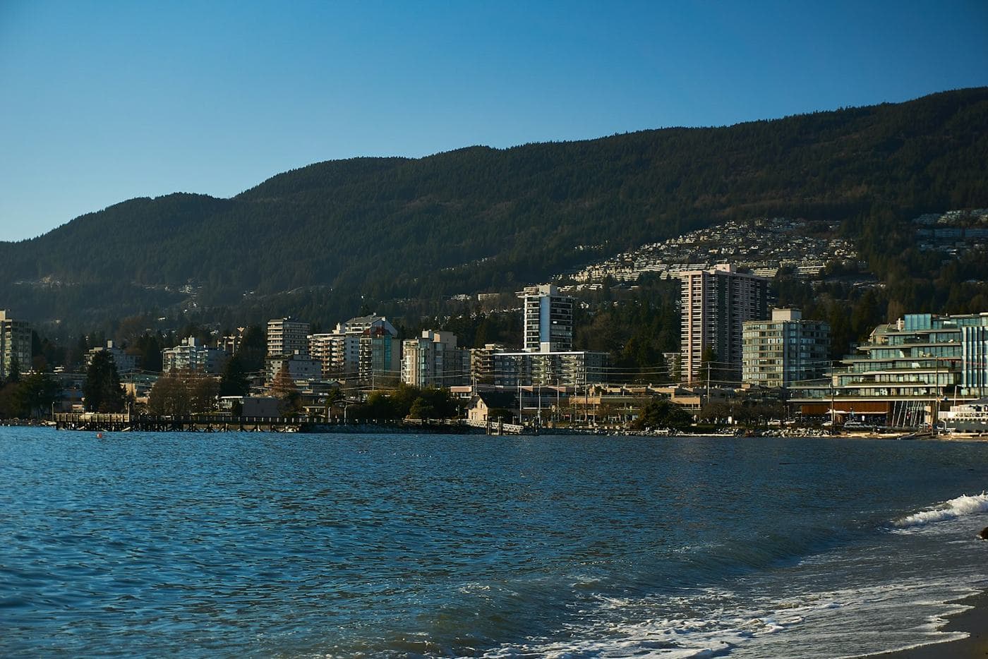 Ambleside waterfront with homes on the hillside behind